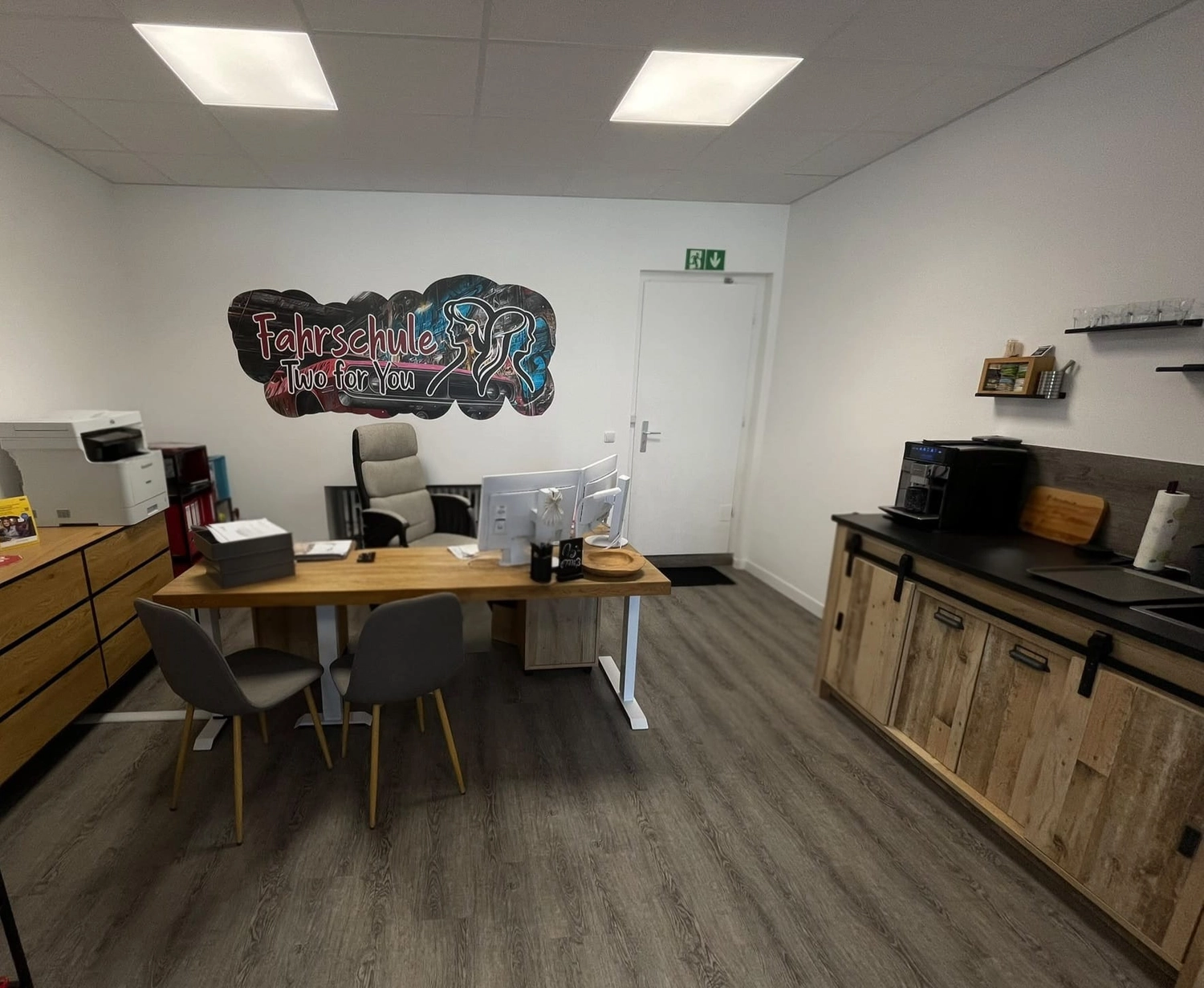 Fahrschule Two for You GmbH – Das Interieur der Fahrschule Two for You mit modernen Holzmöbeln und einer separaten Kaffeestation.